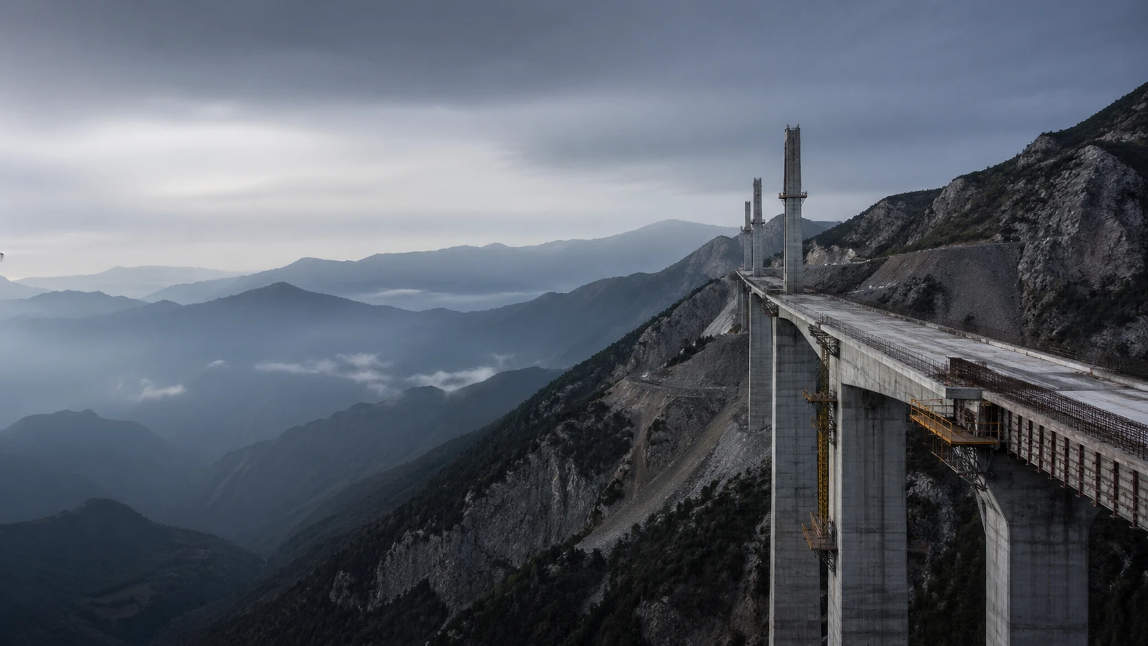 Un puente en construcción entre montañas.